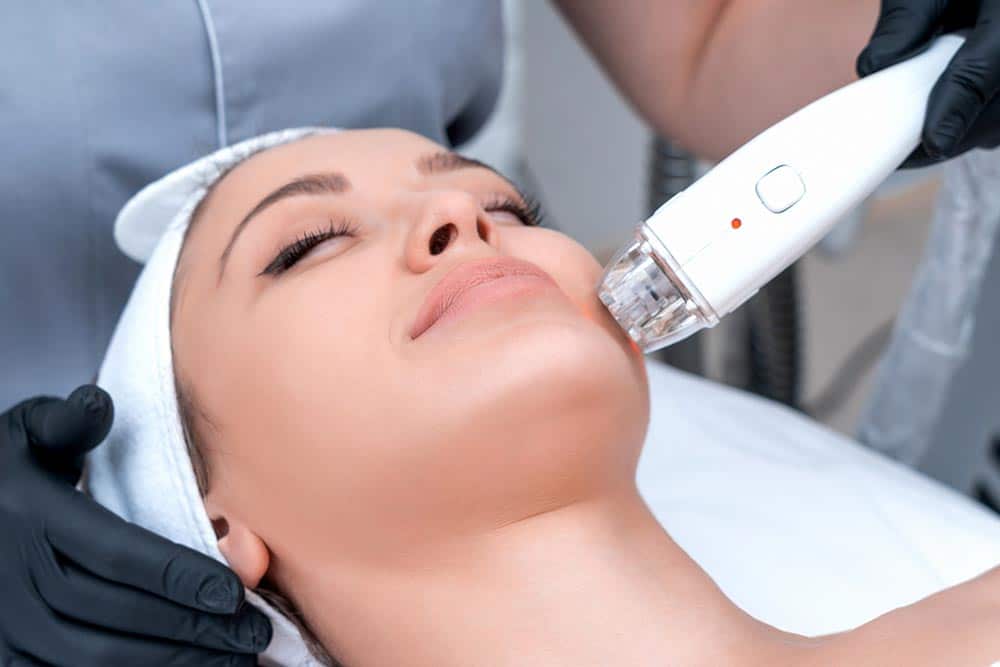 Young woman receiving laser treatment in cosmetology clinic Young woman receiving laser treatment in cosmetology clinic