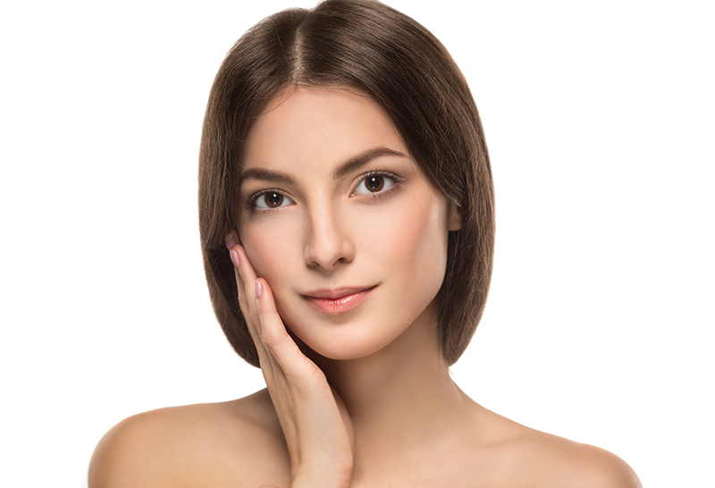 Woman with clear skin, smiling gently