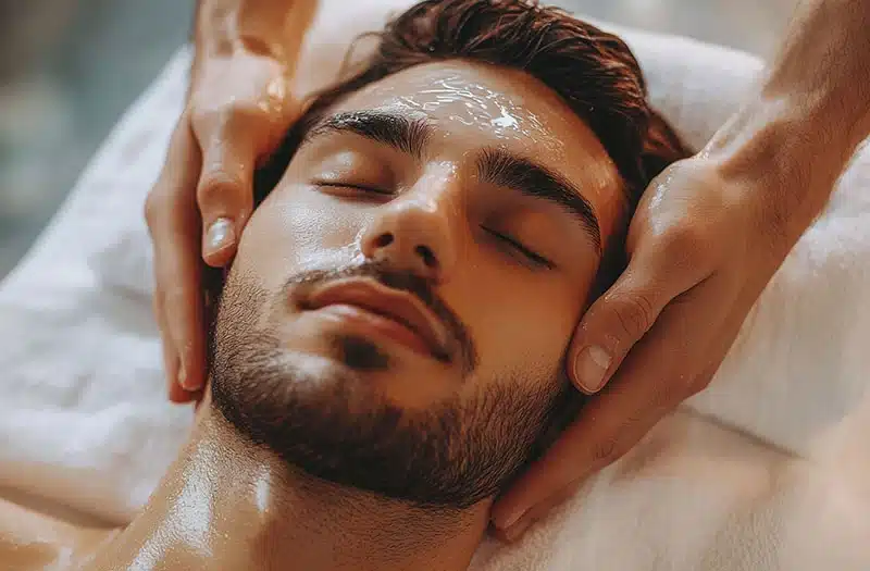 Relaxed man receiving facial treatment.