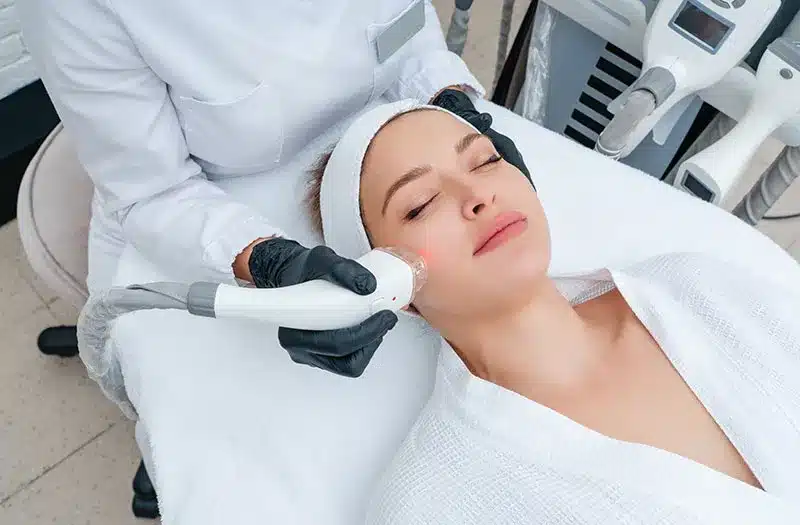 Woman receiving a facial treatment.